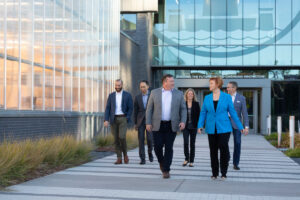 group of people walking out of a building